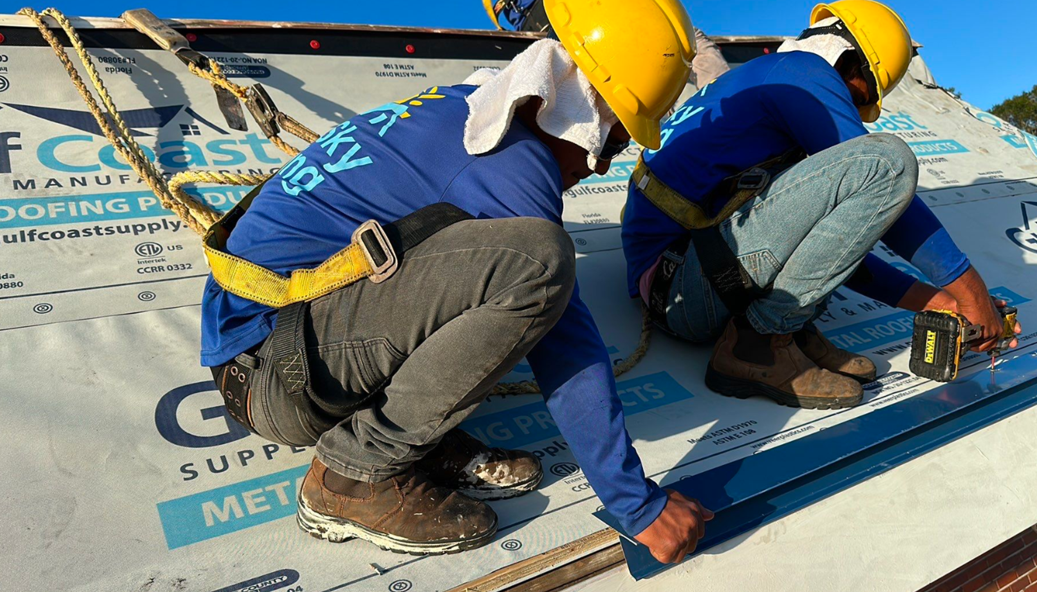 Two roofers working on a roof