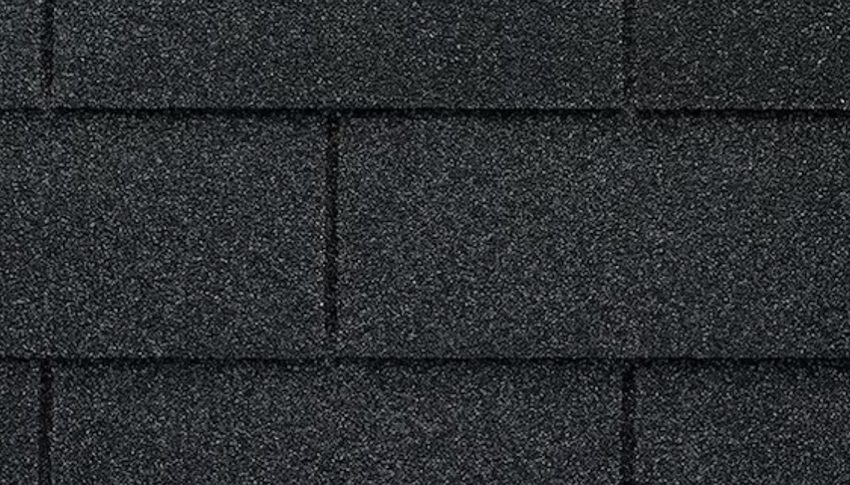 "Close-up of black shingled roof made of asphalt material, providing durable and weather-resistant roofing solution."