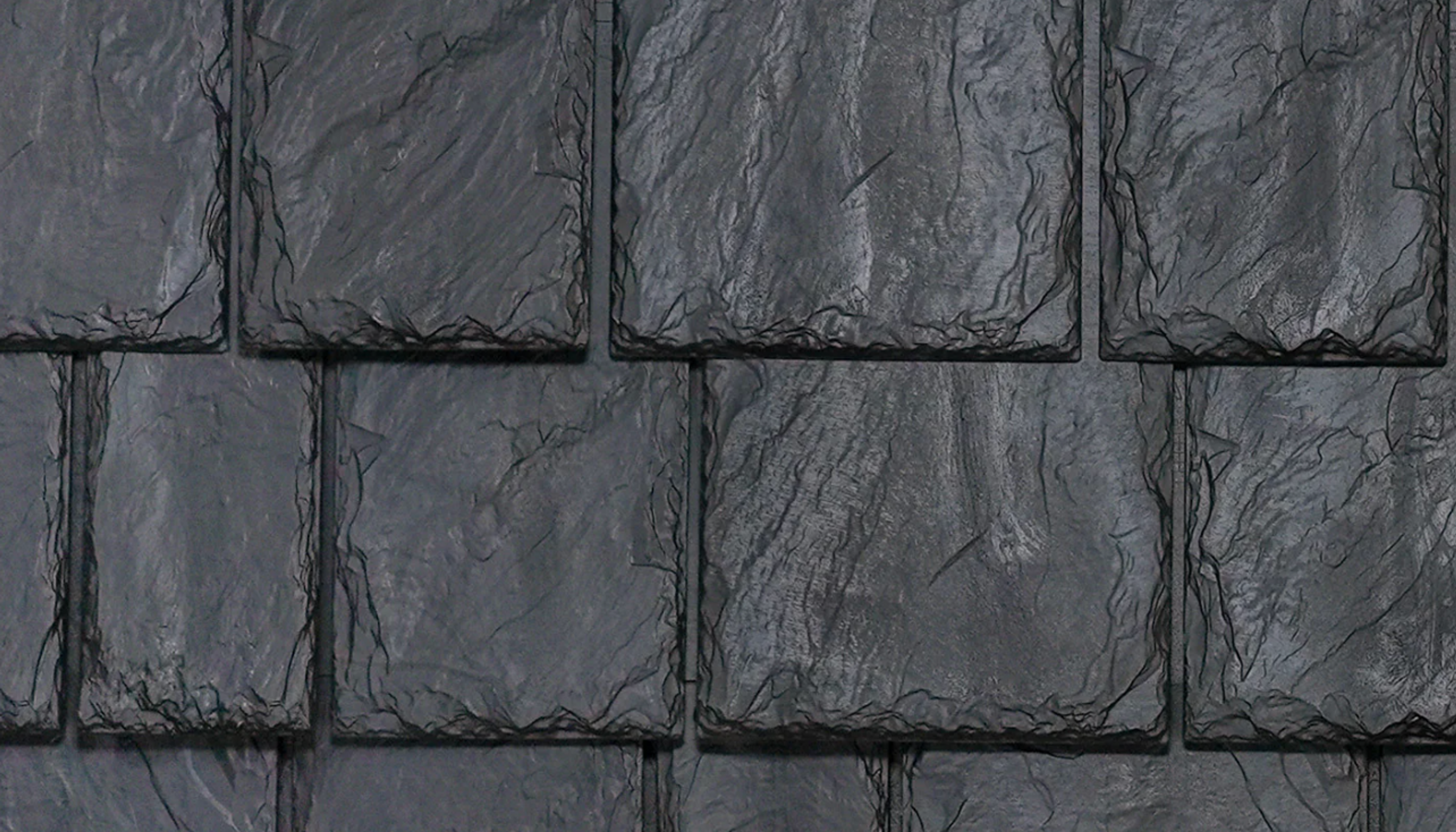 "Composite material black slate roof close-up."